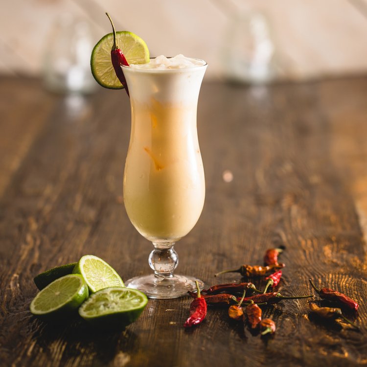 Tall Cream cocktail with spices on table 