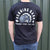 Person wearing a black t-shirt with the Burning Barn logo on it - view of the back