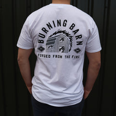 Person wearing a white t-shirt with the Burning Barn logo on it - view of the back